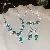 Wholesale Colorful Zircon Leaf Necklace - Trendy Supply - Diamond Round Flower Stud Earrings Bracelet Necklace (Set of Three)